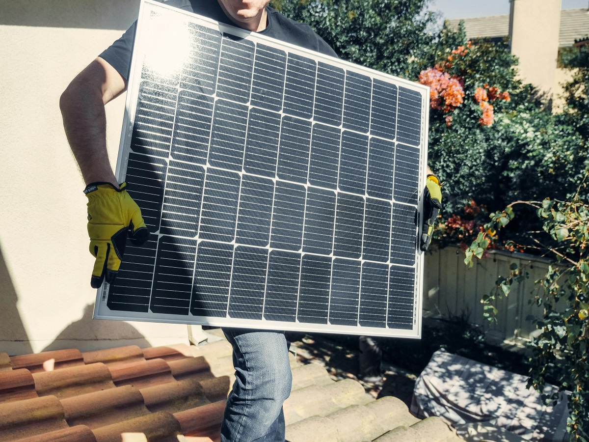 man holding a solar panel